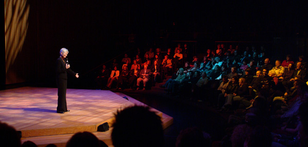 Kate Clinton on stage with audience